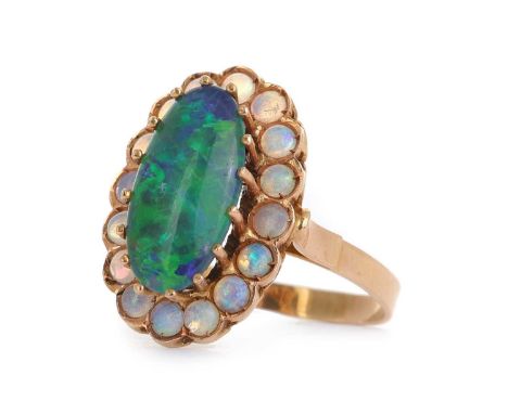OPAL RING, set with a central opal triplet within a halo of small round opals, marked 14, size RQty: 4.5gGenerally worn condi