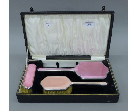 A cased silver and enamel dressing set. The case 36 cm wide. 