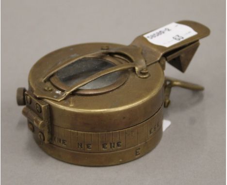 A brass compass. 4 cm high.                               