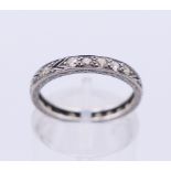 A platinum and diamond eternity ring. Ring size K/L.