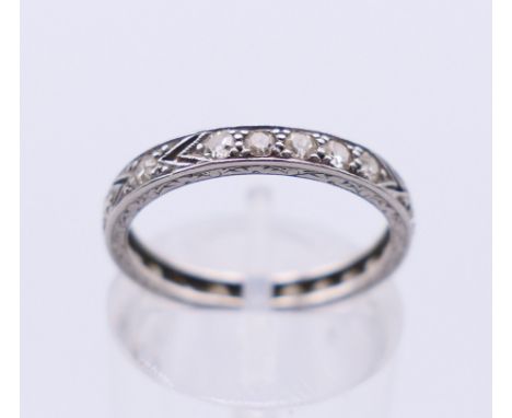 A platinum and diamond eternity ring. Ring size K/L. 