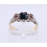 An 18 ct gold diamond and sapphire three-stone ring. Ring size K.