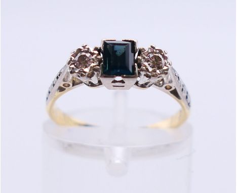 An 18 ct gold diamond and sapphire three-stone ring. Ring size K. 