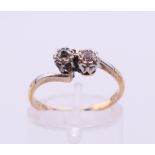 A 9 ct gold and platinum diamond cross over ring. Ring size L/M.