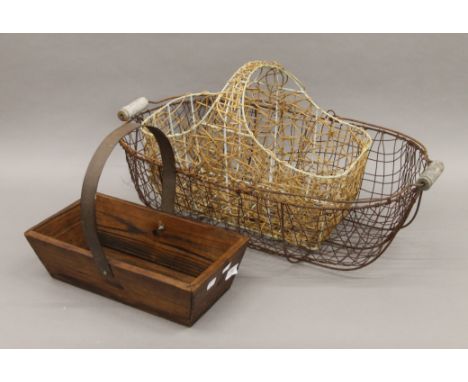 Two wirework baskets and a wooden trug. The largest 65 cm long.