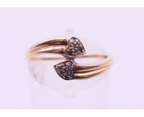 A 9 K gold double heart ring. Ring size N. 