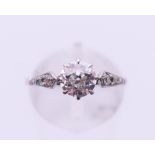 A platinum and diamond ring. The central stone spreading to approximately 0.75 carat. Ring size M.