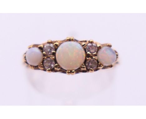 A 9 ct gold, diamond and opal ring. Ring size P/Q. 