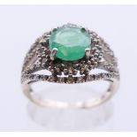 A 9 ct gold emerald and diamond ring. Ring size N.