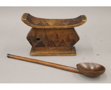 A Southern African head rest with scorched angular and gourd vase decoration, together with a Southern African ladle. The hea