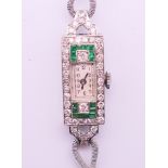 A boxed 9 ct white gold diamond and emerald cocktail wristwatch. 1.2 cm wide. 14.