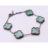 A silver malachite clover bracelet. 18 cm long.