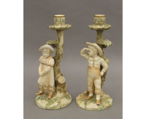 A pair of Royal Worcester blush ivory figural candlesticks, circa 1900. 25.5 cm high