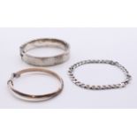 Two silver bangles and a silver bracelet. The bracelet 21 cm long. 35.6 grammes.