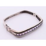 A silver marcasite and amethyst bracelet. 6 cm inner width.