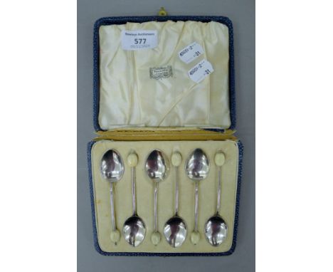 A cased set of silver and enamel coffee bean spoons in an Harrods box. Each 9.5 cm high. 