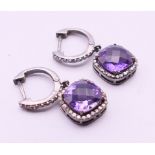 A pair of diamond and amethyst earrings. The drops 1.2 cm high.