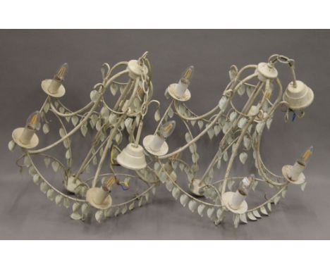 Four white painted chandeliers and a cut glass mounted ceiling light. The largest 60 cm high. 