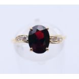 An 18 ct gold diamond and garnet ring. Ring size M.