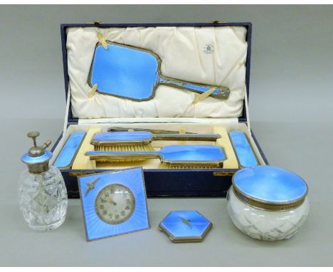 A cased Mappin & Webb silver and enamel dressing table set, together with an enamel desk clock and a compact, each with R.A.F