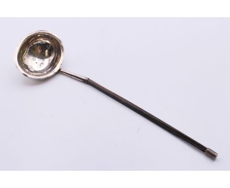 A baleen handled silver toddy ladle, hallmarked for London 1812. 19 cm long.