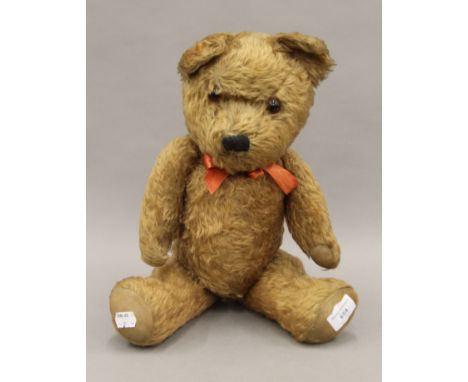 A vintage teddy bear 52 cm high.