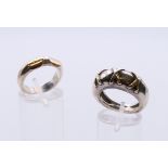 Two unmarked gold mounted silver rings. The largest ring size N/O, the other L.