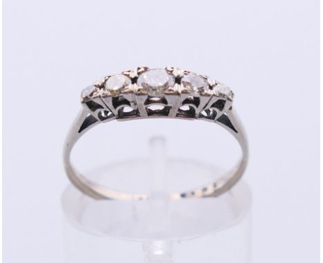 An 18 ct white gold diamond five-stone ring. Ring size K/L. 