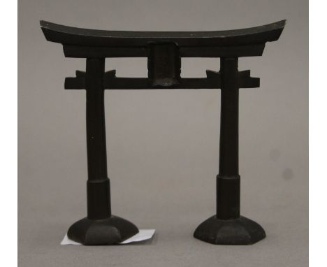 A late 19th/early 20th century bronze model of a Torii (temple) gate. 10 cm wide.