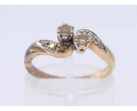 A 9 K gold diamond crossover ring. Ring size L. 
