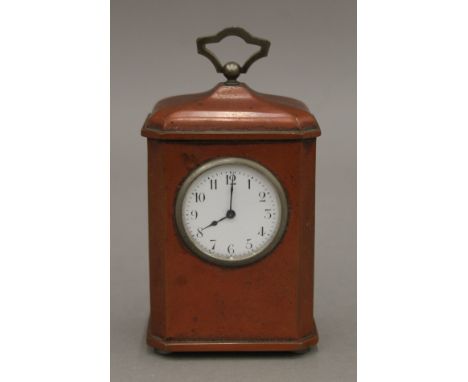 A lacquered carriage clock. 13 cm high. 