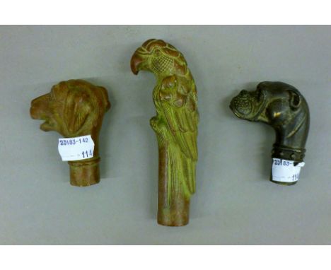 Three bronze walking stick tops. The largest 13 cm high.