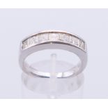 A platinum seven-stone diamond ring. Ring size L/M.