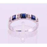 An 18 K white gold diamond and sapphire ring. Ring size L/M.