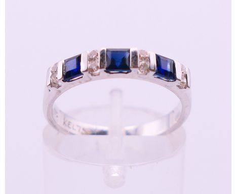 An 18 K white gold diamond and sapphire ring. Ring size L/M. 