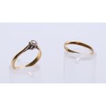 A 22 ct gold and diamond solitaire ring, and a 22 ct gold wedding band.