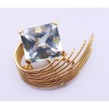A mid-20th century aquamarine brooch, the rectangular-shape aquamarine, to the graduated bar scroll,