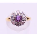 An 18 ct gold diamond and ruby flowerhead ring. Ring size L/M.