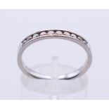 A platinum channel set diamond ring. Ring size O.