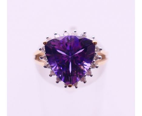 A 9 K gold amethyst and diamond ring. Ring size I/J. 