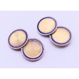 A pair of 14 ct gold cuff links set with a ring of blue enamel,