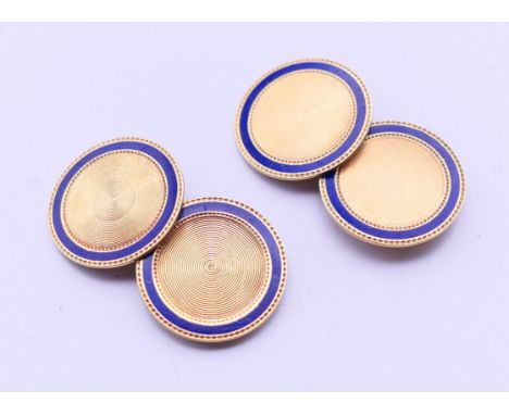 A pair of 14 ct gold cuff links set with a ring of blue enamel, both marked 14 K on both sides of the connecting arm. Each 1.