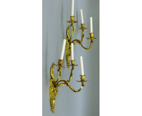 A pair of vintage three-branch ormolu wall candelabra, converted to electricity. 60 cm high overall.