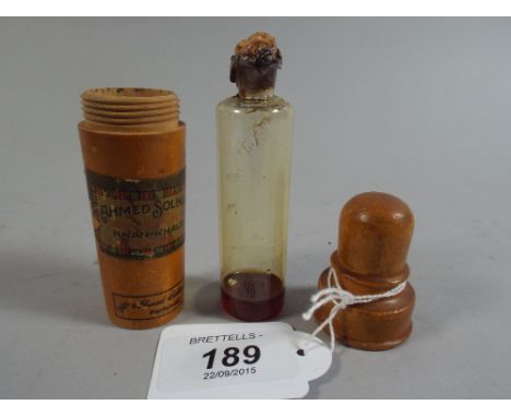 An Egyptian Treen and Glass Perfume Flask Inscribed with Retailers Label Soliman. 