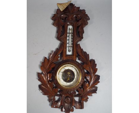 A Carved Black Forest Aneroid Barometer with Temperature Scale Having Original Paper Retailers Label for Carl Muller, Wein, 4