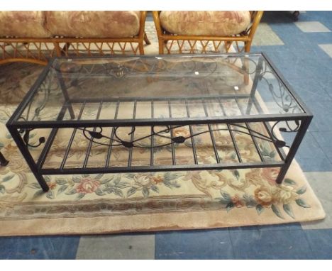 A Wrought Iron and Glass Coffee Table with Stretcher Shelf.