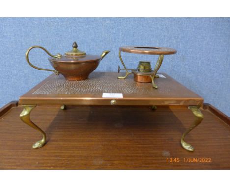 A copper plate on four brass legs with burner and a small copper and brass teapot marked W A S Benson 