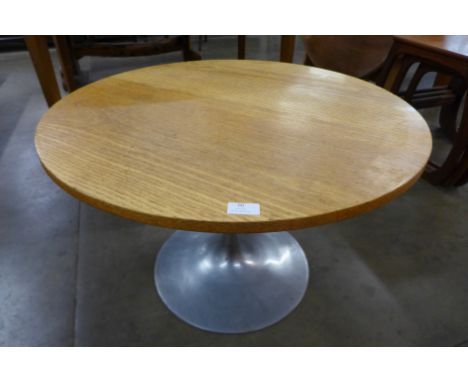 A circular light oak and steel based occasional table 