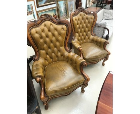 A pair of victorian style leather button-back chairs