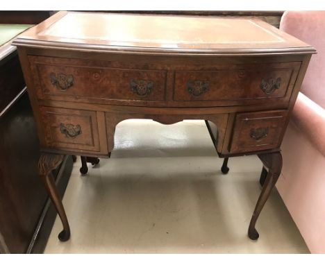 A Georgian-style leather-topped bow-fronted writing desk